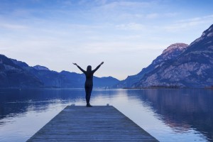 Person on Mountain Lake Pier